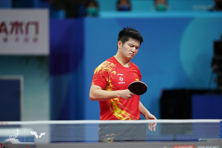 Fan Zhendong ist mit seinem Schläger hingegen nicht zufrieden (©ITTF)